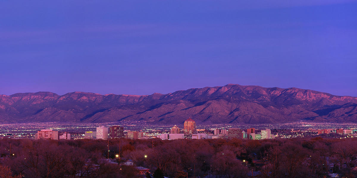 Albuquerque skyline at dusk with mountains in background